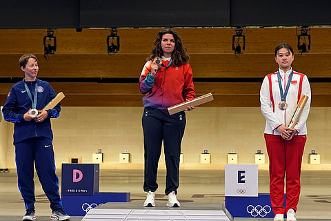 Women’s 50m rifle 3 positions: Gold medalist Switzerland's Chiara Leone, center, and the silver medalist Sagen Maddalena of the United States, left, and bronze medalist China's Zhang Qiongyue